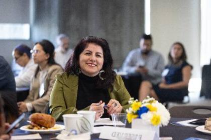 Dr. Nancy Gutierrez seated at a table during the Celebration of 教育 event